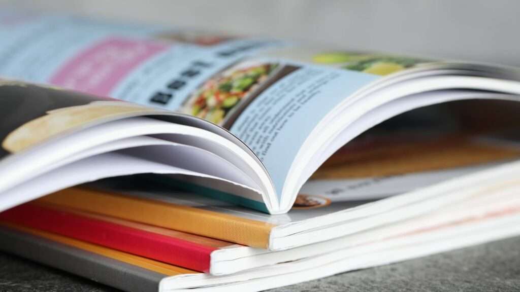 A stack of professional instructional manuals with custom covers, illustrating various printing options available in South Africa.