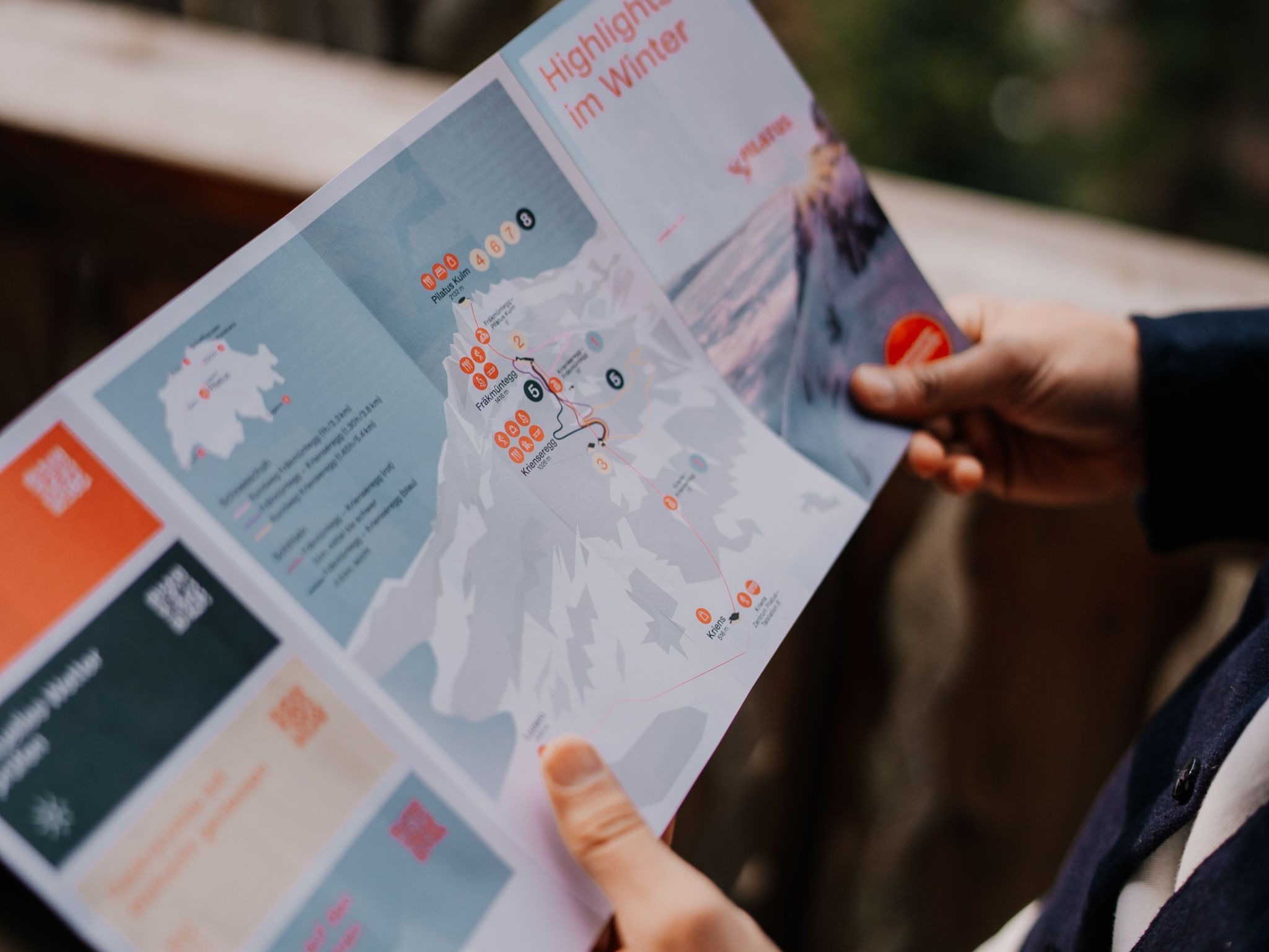 Person holding a printed event flyer with map and highlights — business flyer printing by Print It ZA